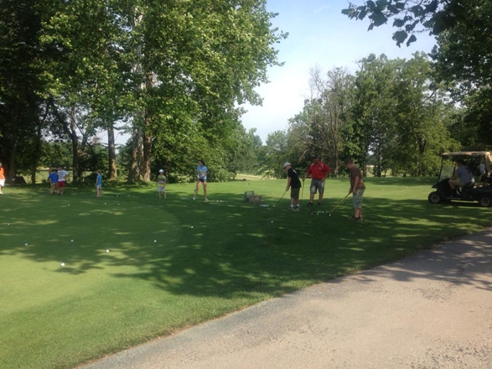 golfers at the practice green