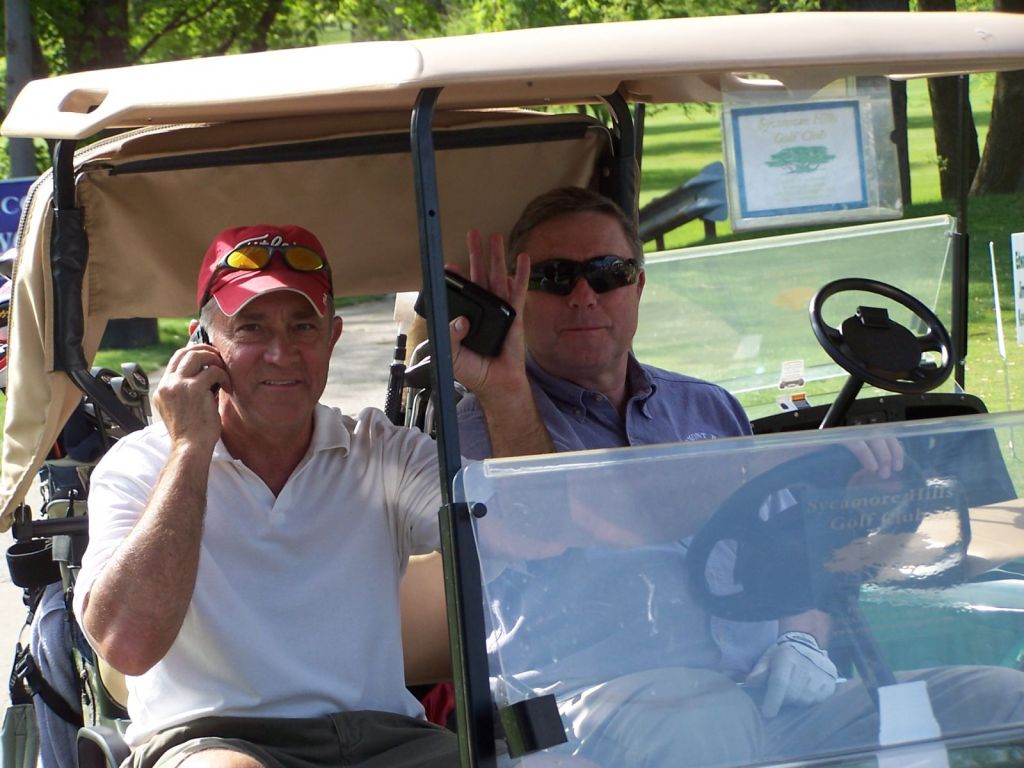 two golfers riding on golf cart