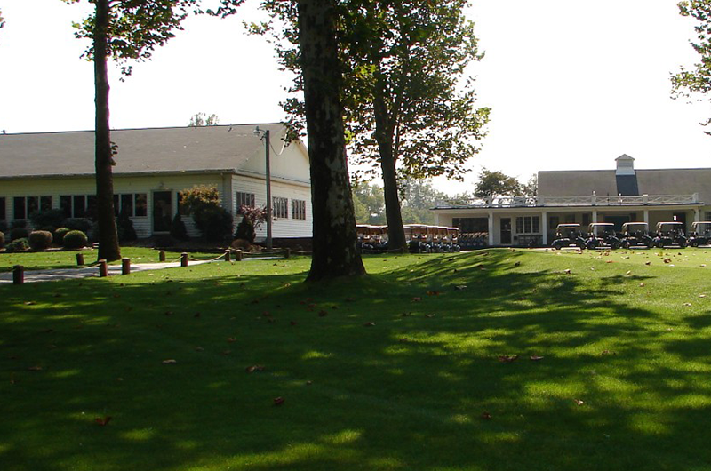 view of golf course green with club in foreground